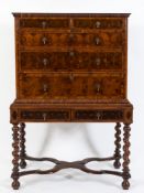An early 18th Century walnut oyster veneer crossbanded and inlaid chest on later stand:,