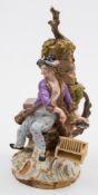 A Meissen figure of a rat catcher: the smiling youth holding a rat above a basket at his side,