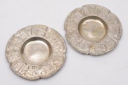 A pair of Dutch silver dishes: the border decorated with cartouches of floral sprays and a