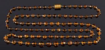 A long, faceted bead citrine single string necklace:, approximately 126cm long.