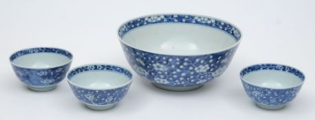 A Chinese porcelain bowl and three smaller: each painted in blue to the interior and exterior with