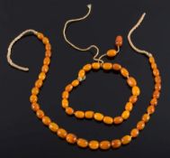 Two short, single-strings of small, amber coloured beads:, 19gms gross weight.