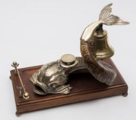A late 19th century ram's horn and plate mounted desk stand: in the form of a dolphin with cast