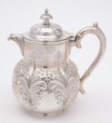 A Victorian silver embossed hot water jug, maker Walker & Hall, Sheffield, 1899: monogrammed,