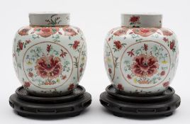 A pair of Chinese famille rose ginger jars and covers: each painted with four circular panels