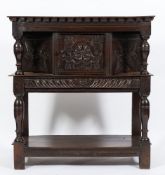 A 17th Century carved oak court cupboard:, of small size, the top with a dentil edge,