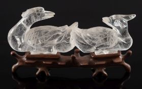 A Chinese hardstone carving and a rock crystal carving: the first of a bird resting on two peaches