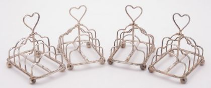 A set of four Edward VII silver four-division toast racks, maker Atkin Brothers, Sheffield, 1903:,
