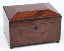 A 19th century mahogany tea caddy:.
