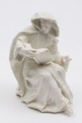 An early Bow white figure of a seated monk with 'To' mark: reading from a book and wearing a hooded