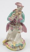 A Derby 'Pale Family' figure of a piper: wearing a pink tricorn hat,