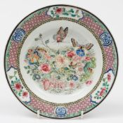 A Chinese famille rose dish: finely painted with a vignette of two butterflies, flowers and foliage,