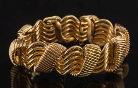 A gold bracelet of woven linking: approximately 85gms gross weight, drop lacking.
