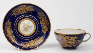 A later decorated Sèvres cup and saucer: the ogee cup finely painted with a courting couple in a