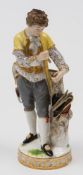 A Meissen porcelain figure of a gardener: modelled after the original by Victor Michael Acier,