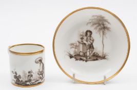 A Guérhard & Dihl (Paris) porcelain coffee can and saucer: painted en grisaille with a young