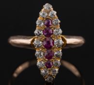 A gold, ruby and diamond marquise shaped cluster ring: the central, single row of graduated rubies,