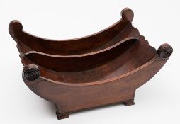 A 19th century mahogany cheese coaster: of crescent -shaped outline, with ring turned roundels,