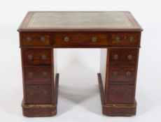 A Victorian mahogany pedestal desk:, the top inset with a panel of tooled leather,
