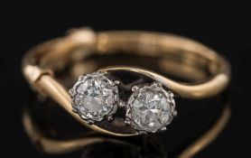 A diamond two-stone cross over ring: with circular, brilliant-cut diamonds,