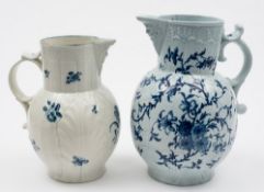 A large Worcester blue and white cabbage leaf jug and a similar later jug: the first with mask head