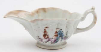 An early Worcester small sauceboat: of oval fluted form with flared rim and scroll handle,