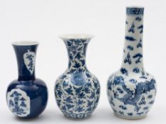 A Chinese blue and white bottle vase and two similar baluster vases: the first painted with two