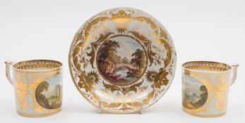 A pair of Derby topographical coffee cans and a saucer: the cans of cylindrical form with wishbone