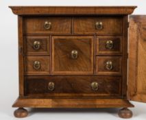 A walnut collector's cabinet:,
