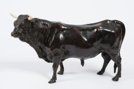 After Bayre, a bronze study of a bull: it's head turned slightly left, with inset ivory horns, 35cm.