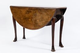 A George II mahogany oval drop flap dining table:,