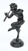 A 19th century bronze figure of a satyr : playing pipes whilst dancing, raised on a socle base,