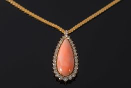 An 'angel' skin coral and diamond tear-drop pendant necklace: with single pear-shaped 'angel-skin'