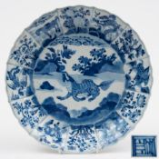 A Chinese blue and white moulded dish: painted to the centre with a mythical beast and a flying