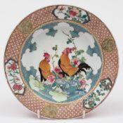 A Chinese ruby-backed famille rose dish: finely painted with a pair of cockerels in a garden
