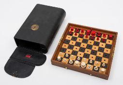 A Jaques 'Status Quo' bone travelling chess set: one side stained red, the other side left natural,