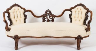 A Victorian carved walnut twin chair back settee:,