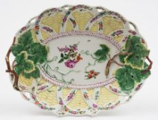 A Worcester yellow-ground oval dish: of moulded basket form with branch handles,