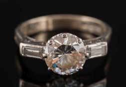 An 18ct white gold and diamond single stone ring:, the circular,
