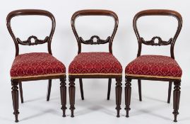 A set of six Victorian carved rosewood dining chairs:,