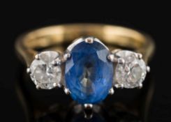 An 18ct gold, sapphire and diamond three-stone ring:,