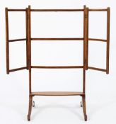 An early 19th Century mahogany triple folding towel rail:, on incised reeded dual splayed legs,