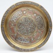 An Indo-Persian brass and silver inlaid tray: of circular outline.