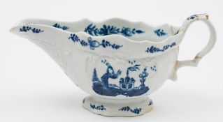 A Bow blue and white sauceboat: with scroll handle and moulded with cartouches and floral sprays,
