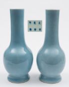 A pair of Chinese claire-de-lune glazed bottle vases: each with cylindrical neck and on spreading