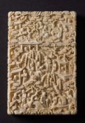A 19th century Cantonese carved ivory card case and cover: with all over decoration of figures in a
