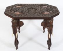 An Indian carved hardwood octagonal occasional table:, the top decorated with flowerheads,