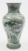 A Chinese famille verte baluster vase: finely painted on a floral moulded ground with a continuous