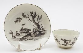 A Worcester First Period tea bowl and saucer: printed in black with a variation of Robert Hancock's