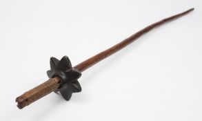 A Vanuatu war club: the slender shaft with cane binding to one end and having a stella -shaped